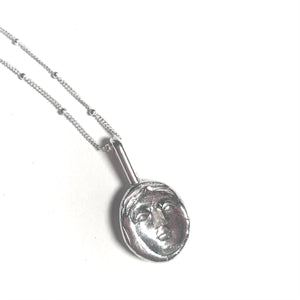 Concave face necklace